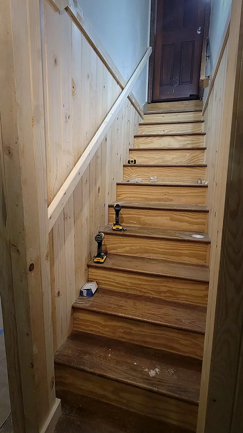 Pine-paneled stairwell with custom handrail