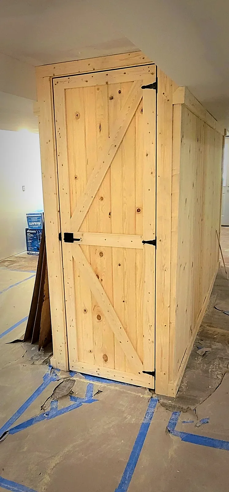 Custom board-and-batten storage closet, built beneath the stairs